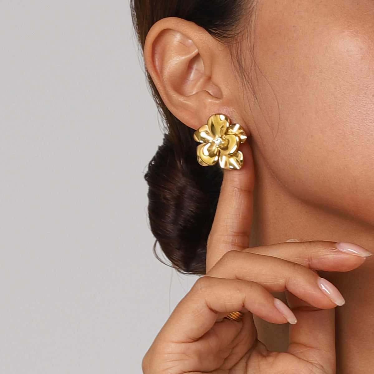 Gold flower stud earring with clear center stone, elegant design for women