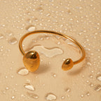 Close up of polished gold open cuff bracelet with smooth metallic finish