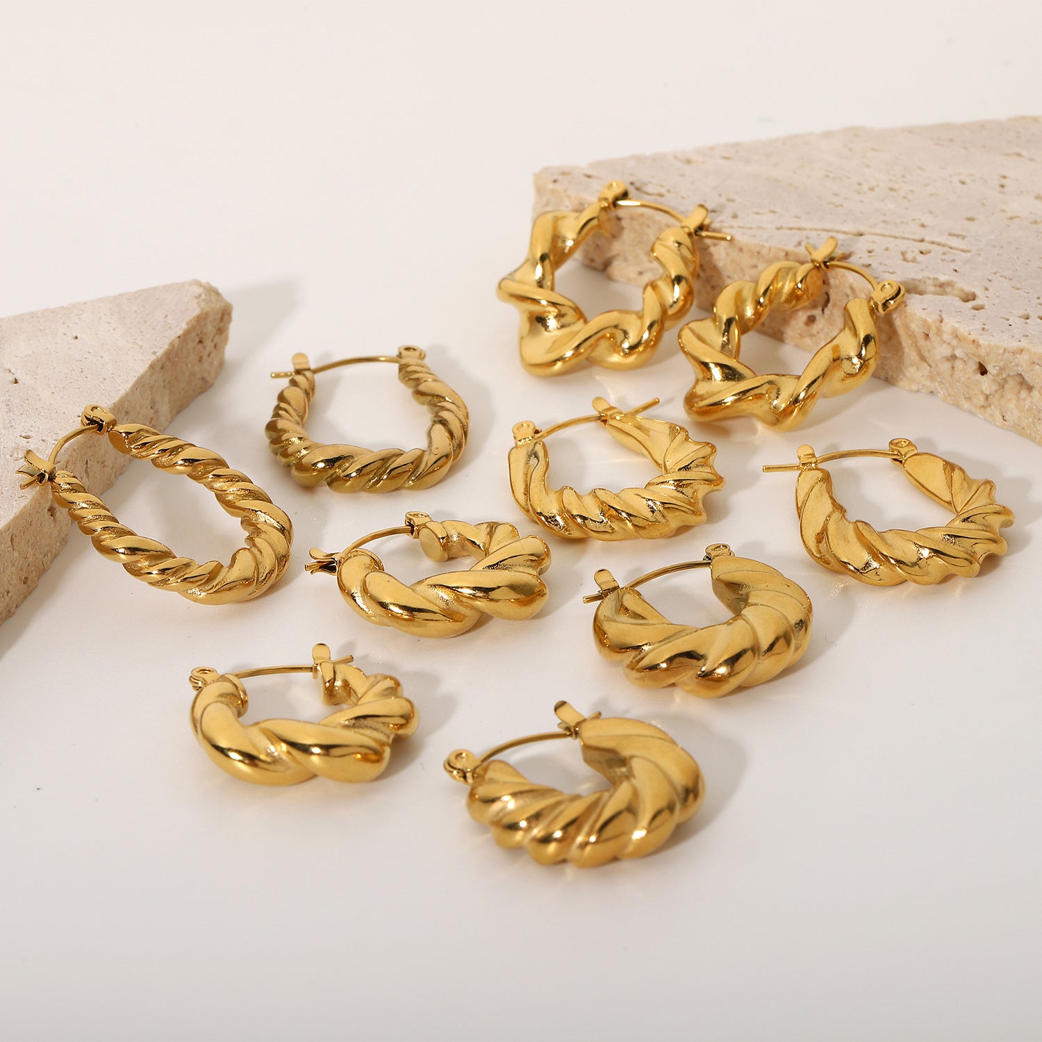 Gold twisted hoop earrings, shiny golden color, women's jewelry