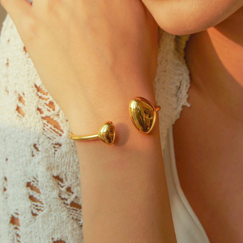 Minimalist gold open cuff bracelet on wrist