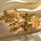 Gold floral butterfly ring and earring set with green stone accent