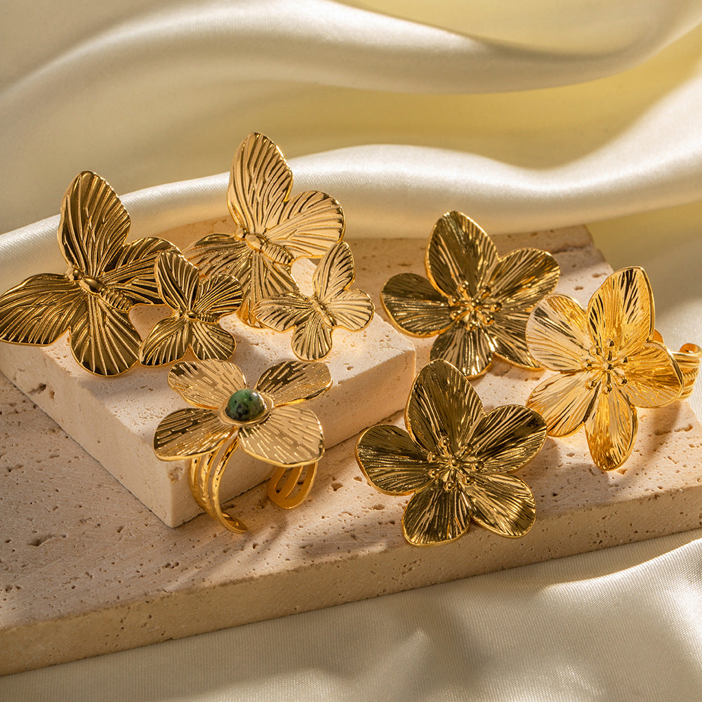 Gold floral butterfly ring and earring set with green stone accent