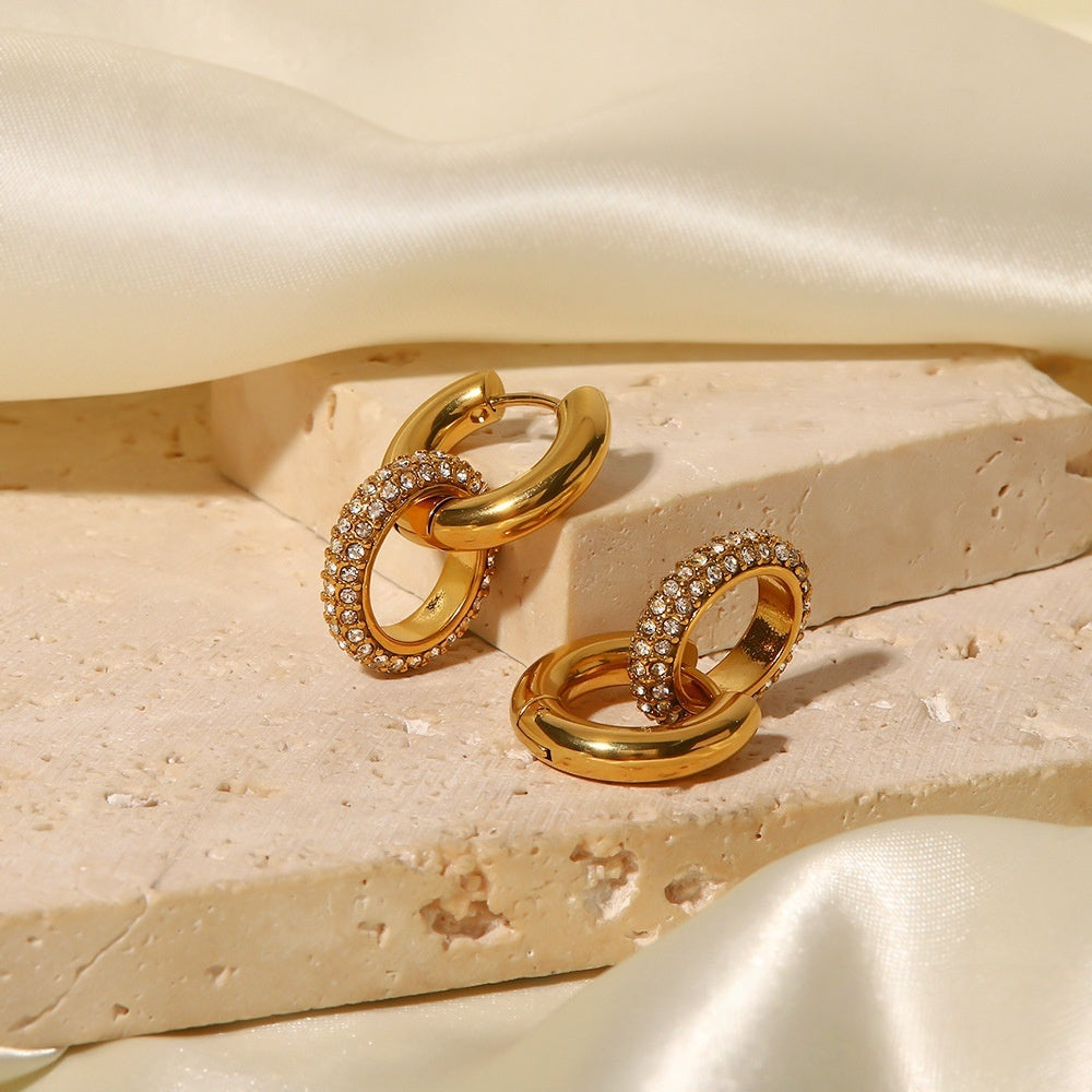 Interlocking hoop gold earrings with smooth and crystal-studded design for women