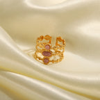 Close-up of pink stone accents on gold geometric adjustable ring