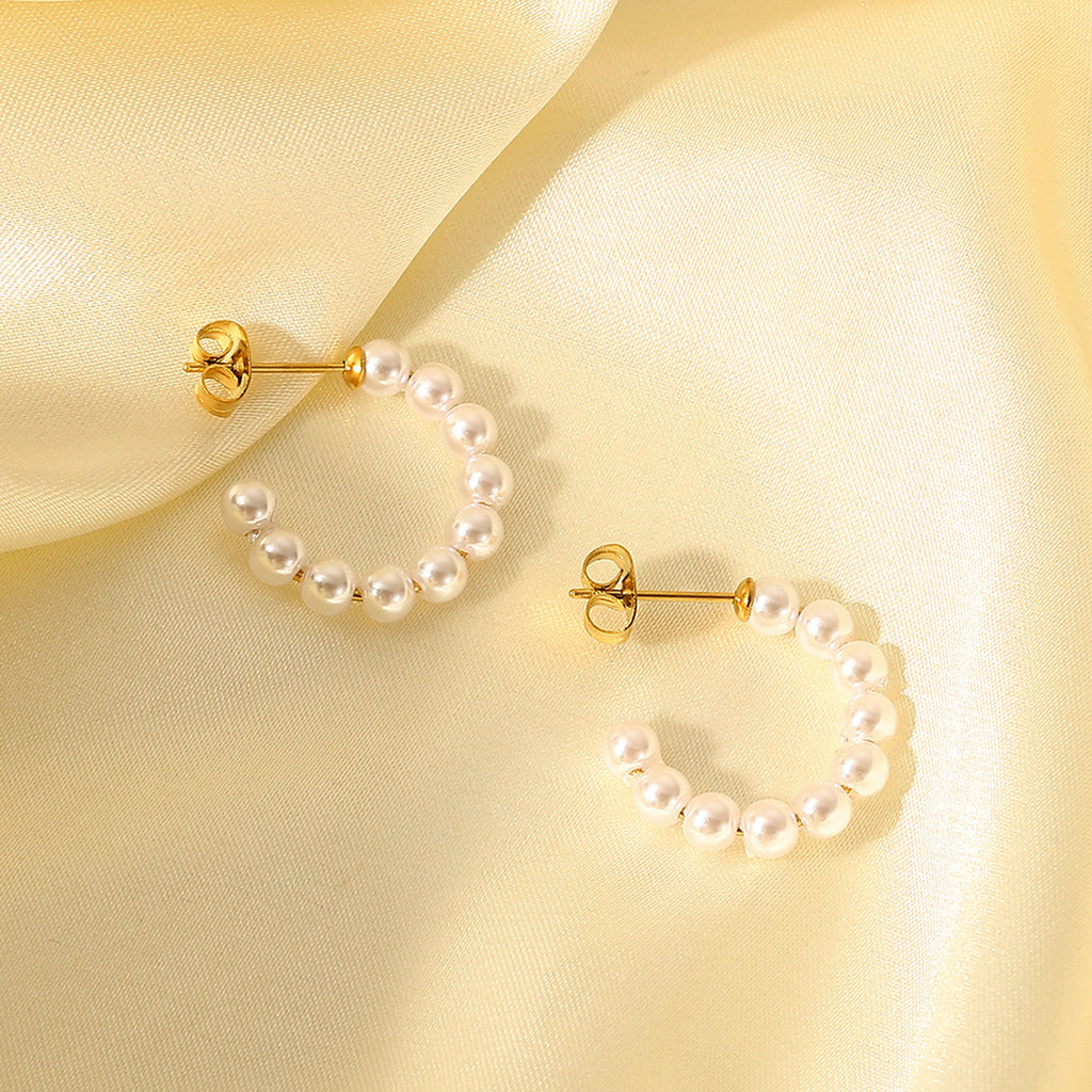 Gold C-shaped hoop earrings with small white pearls for women