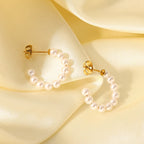 Women wearing gold C-pearl hoop earrings for everyday style